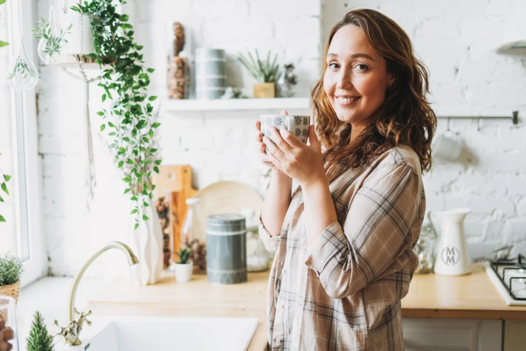 Woman relaxing with tea, reflecting on her hormonal health