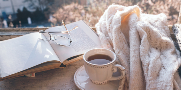 A Present You1 soft wellness still life with journal, tea, glasses, and sunlight symbolizing calm midlife clarity