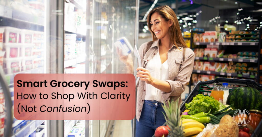 Woman shopping with a thoughtfully filled grocery cart focused on whole foods and smart grocery swaps